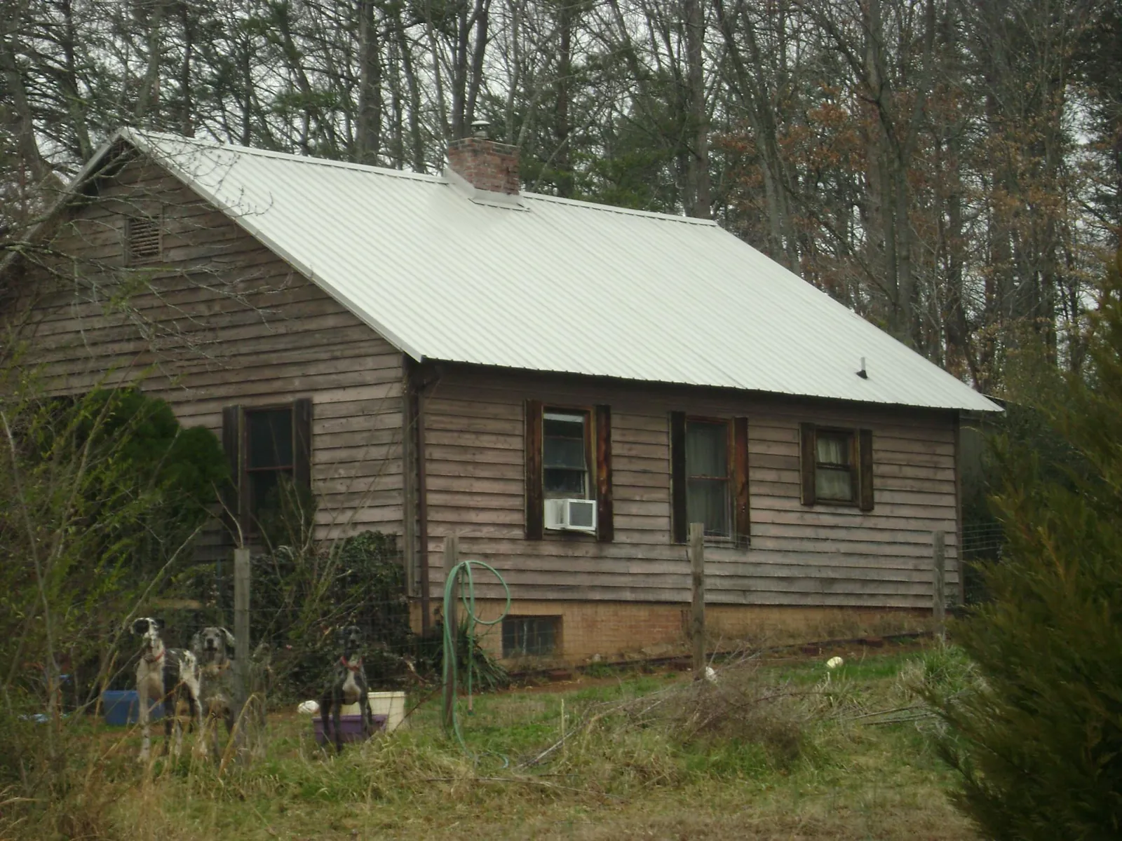 White metal roof on an old wood sided farmhouse, from a Metal Roof Installation job in Canmer